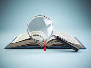 magnifying glass over open book depicting micro lessons