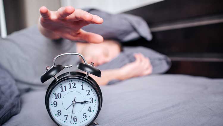An image of stopping an alarm clock because you don't have time for it.