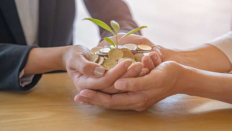 An image of a handful of coins showing wealth.