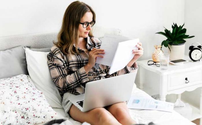 Female Fundraiser Relaxed on Bed Working From Home